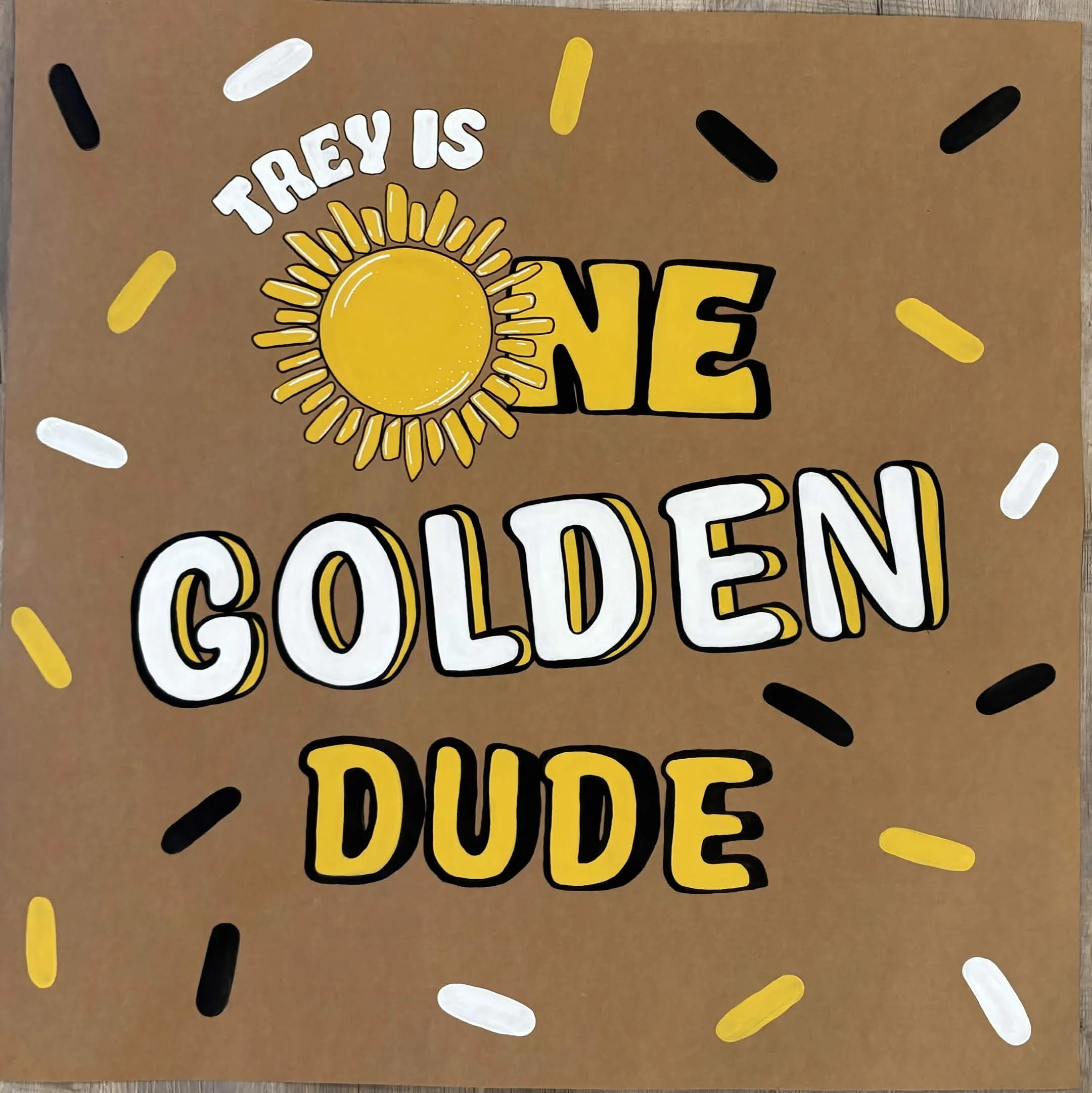 Black, white, and golden One Golden Dude first birthday banner for Trey with a painted sun